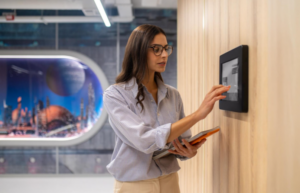 Employee using biometric time attendance system in modern office environment