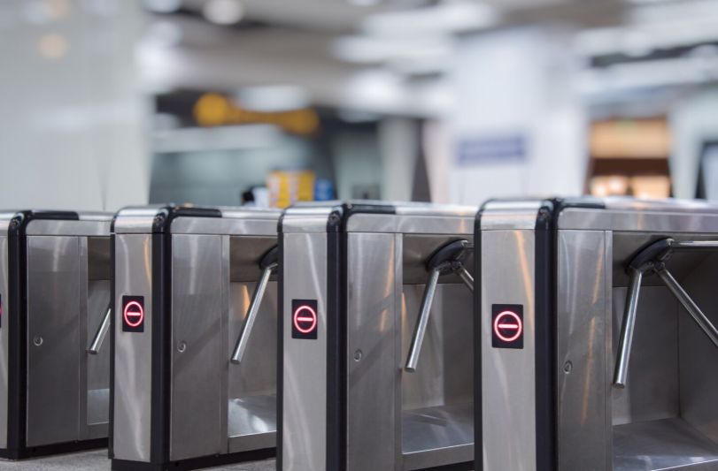 Flap barrier turnstile for controlling employee entry at busy office entrance